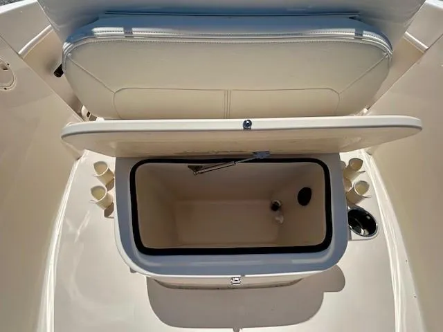 Slide: The Image of 2020 Grady-White Fisherman 180 boat storage compartment with open lid and cup holders. - 10