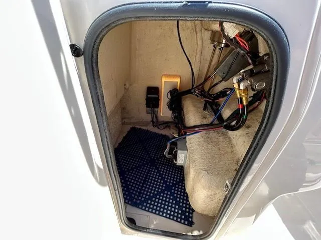 Slide: The Image of 2020 Grady-White Fisherman 180 storage compartment with wiring and equipment. - 11