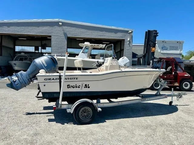 Slide: The Image of 2020 Grady-White Fisherman 180 boat on trailer, parked outside a service garage. - 2