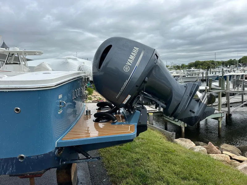 Slide: The Image of 2020 Regulator 23 Forward Seating boat with Yamaha outboard motor at a marina. - 14