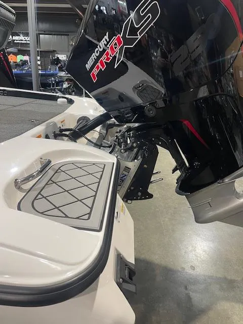 Slide: The Image of 2025 Caymas CX21Pro boat with Mercury Pro XS engine in showroom. - 3