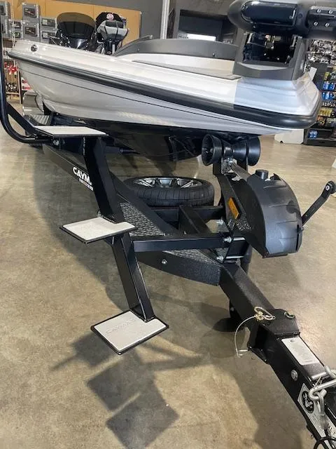 Slide: The Image of 2025 Caymas CX21Pro boat on trailer in showroom setting. - 7
