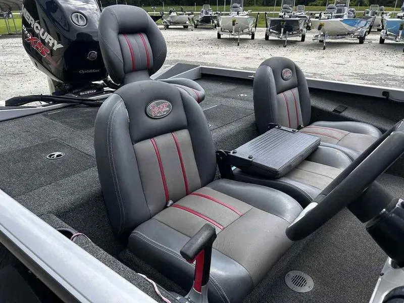 Slide: The Image of 2016 Ranger RT188 boat interior with gray and red seats, featuring a Mercury engine. - 14