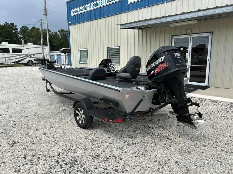 Slide: The Image of 2016 Ranger RT188 boat with Mercury engine parked outside a building. - 2