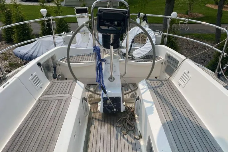 Slide: The Image of Cockpit of 1992 Nautor Swan 44 sailboat with dual steering wheels and wooden deck. - 2