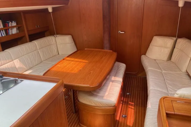 Slide: The Image of Interior of 1992 Nautor Swan 44 yacht with wooden table and white seating. - 3