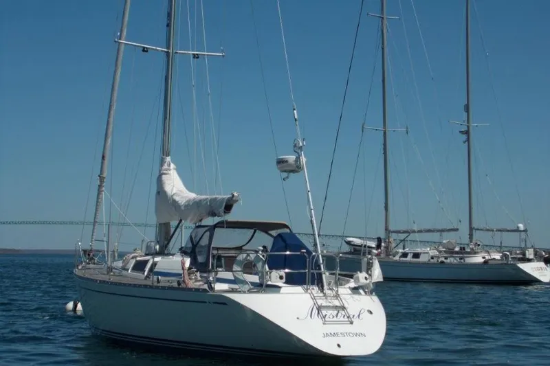 Slide: The Image of Sailing yacht Nautor Swan 44, 1992 model, anchored in calm blue waters. - 8