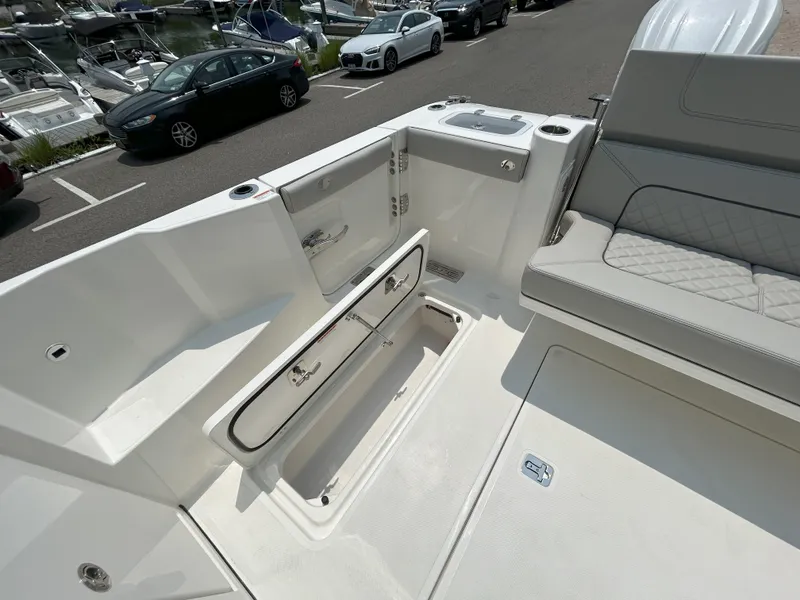 Slide: The Image of 2026 Pursuit DC 326 boat deck with seating and storage compartments. - 11