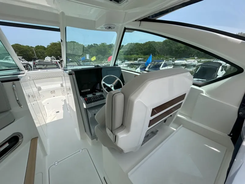 Slide: The Image of Interior of 2026 Pursuit DC 326 boat with modern helm and seating. - 13