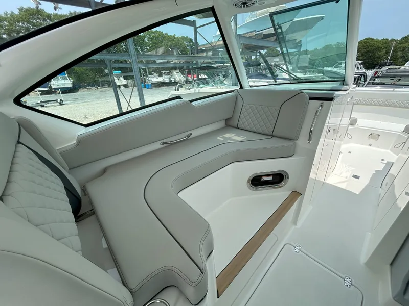 Slide: The Image of 2026 Pursuit DC 326 boat interior with luxurious seating and modern design. - 15