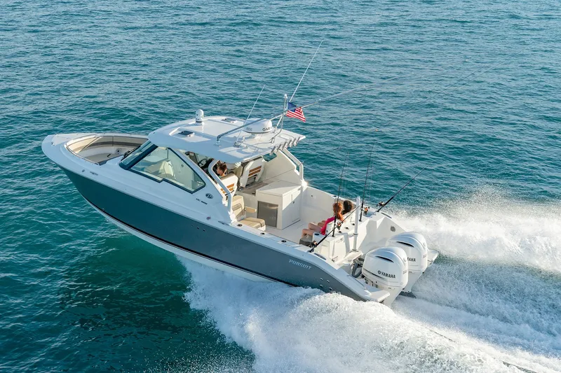 Slide: The Image of 2026 Pursuit DC 326 boat cruising on open water with passengers onboard. - 21