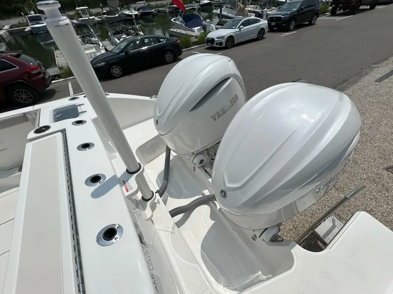 Slide: The Image of 2026 Pursuit DC 326 boat with dual Yamaha outboard engines at a marina. - 5