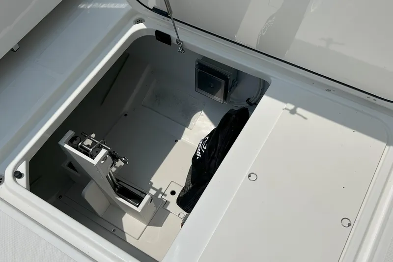 Slide: The Image of Open storage compartment on 2026 Pursuit DC 326 boat, showcasing interior space. - 9