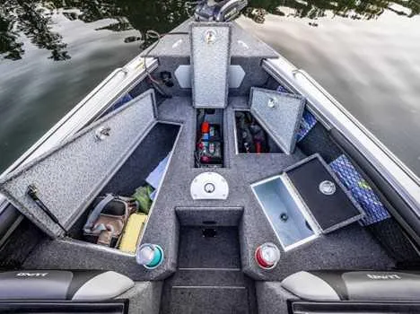 Slide: The Image of 2026 Lund 1975 Tyee boat interior with gray carpet and storage compartments. - 3
