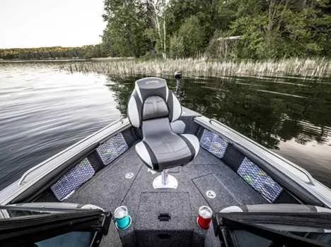 Slide: The Image of 2026 Lund 1975 Tyee boat interior with steering wheel, cup holders, and branded seating. - 5