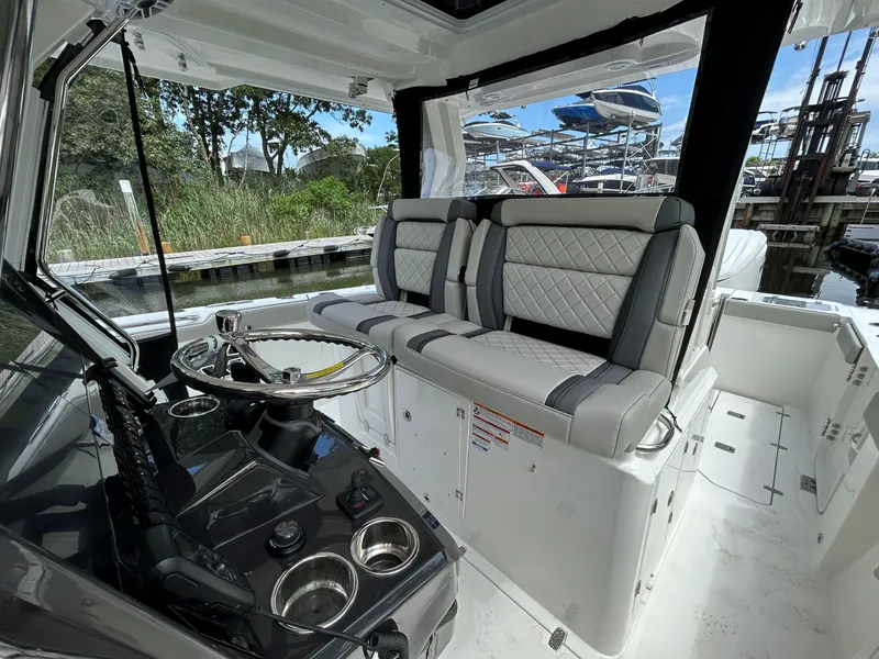 Slide: The Image of Interior of 2026 Pursuit S 328 boat with luxurious seating and steering wheel. - 10