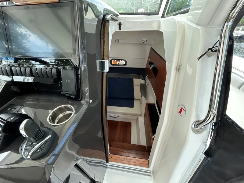 Slide: The Image of Interior view of 2026 Pursuit S 328 boat cabin with modern controls and seating. - 17