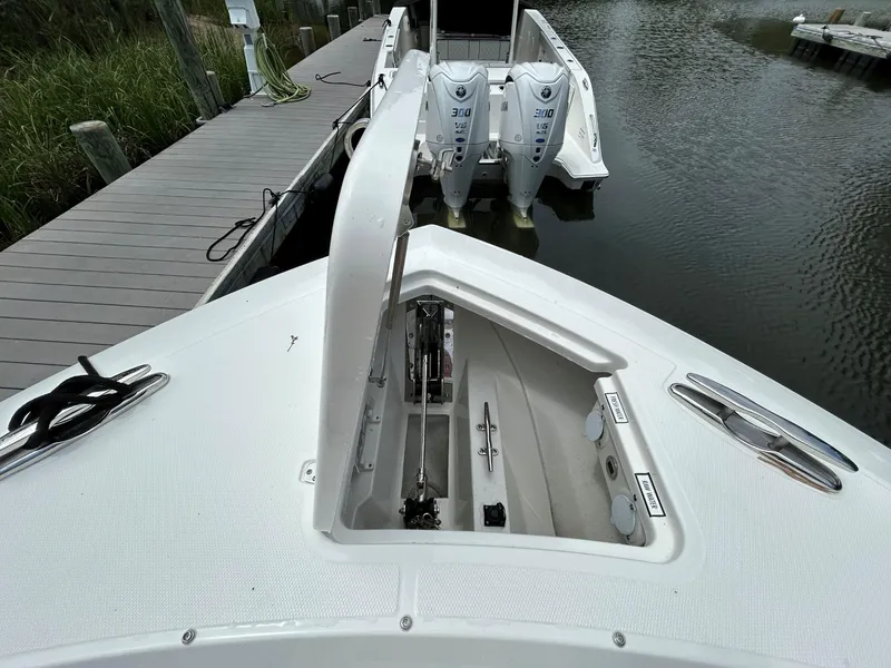 Slide: The Image of 2026 Pursuit S 328 boat with open anchor hatch, docked by the water. - 26