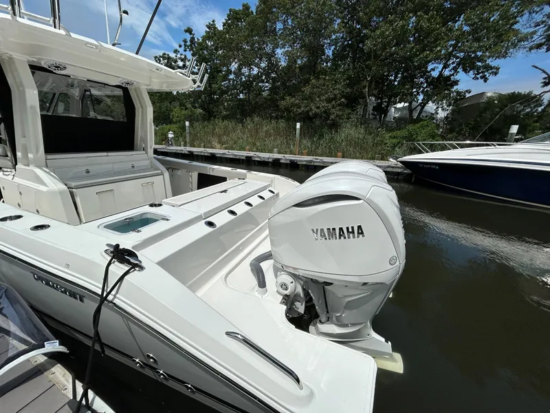 Slide: The Image of 2026 Pursuit S 328 boat with Yamaha outboard engine docked by the water. - 3