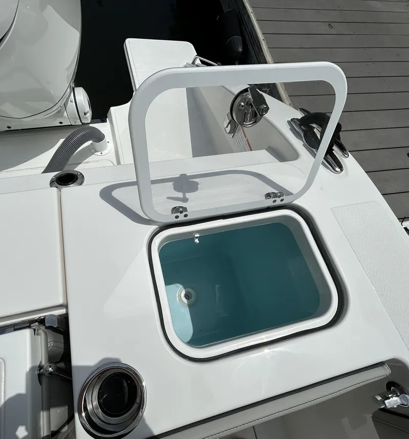 Slide: The Image of 2026 Pursuit S 328 boat with open storage compartment on deck. - 4
