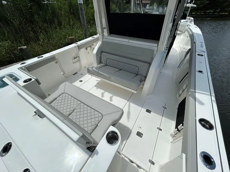 Slide: The Image of 2026 Pursuit S 328 boat interior with cushioned seating and cup holders. - 6