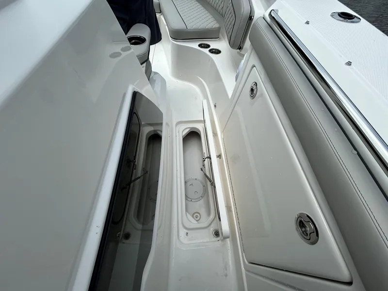 Slide: The Image of 2026 Pursuit S 328 boat interior with storage compartments and seating. - 7