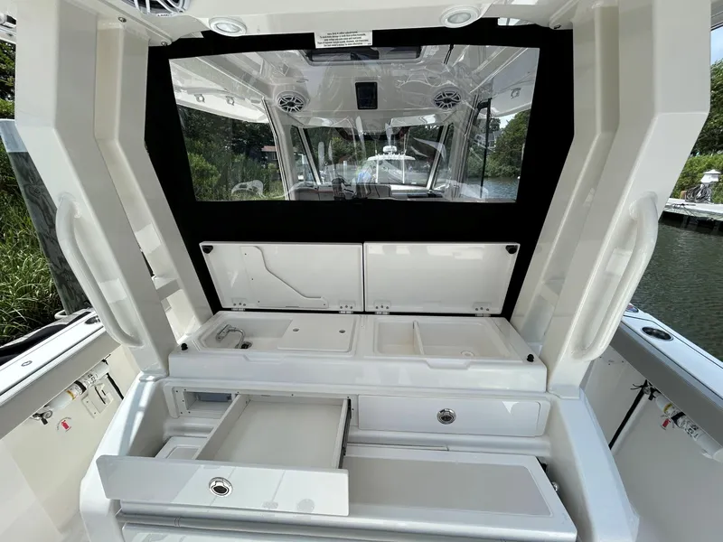 Slide: The Image of 2026 Pursuit S 328 boat interior with storage compartments and sleek design. - 8