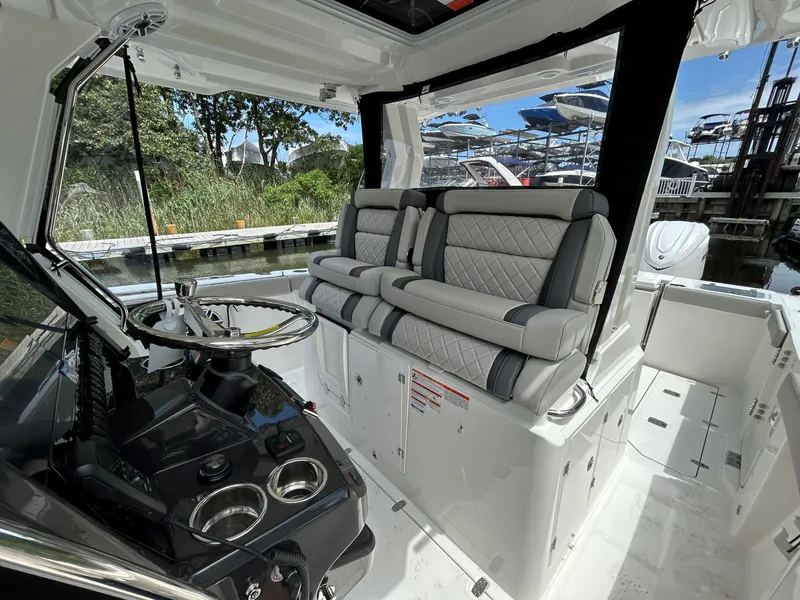 Slide: The Image of 2026 Pursuit S 328 boat interior with luxurious seating and modern helm controls. - 9