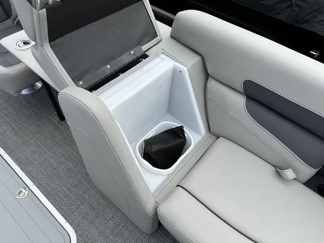 Slide: The Image of 2025 Barletta Boats C20UC interior with open storage compartment and gray seating. - 13