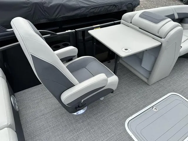 Slide: The Image of 2025 Barletta Boats C20UC interior with gray seating and table setup. - 15