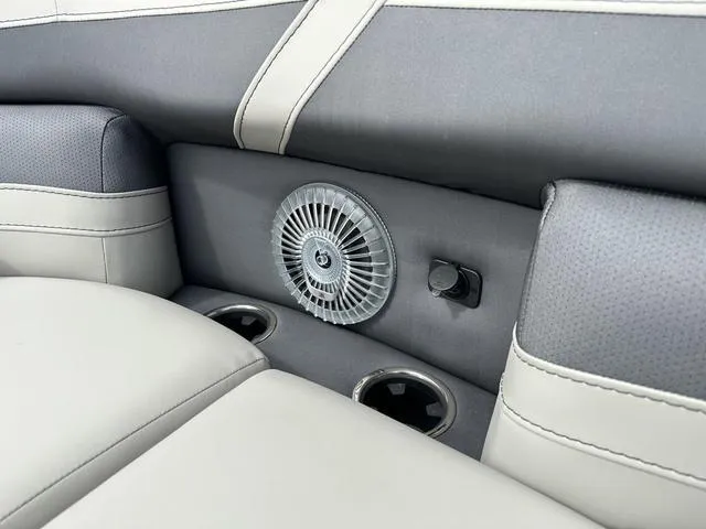 Slide: The Image of Barletta Boats C20UC 2025 interior with fan and cup holders, featuring gray and beige seating. - 21