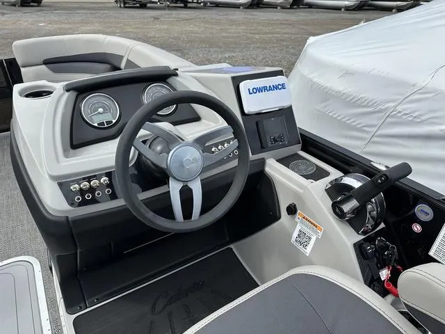 Slide: The Image of 2025 Barletta Boats C20UC dashboard with steering wheel, gauges, and Lowrance navigation system. - 26