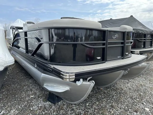 Slide: The Image of 2025 Barletta Boats C20UC pontoon, sleek design, parked on gravel, under cloudy sky. - 3