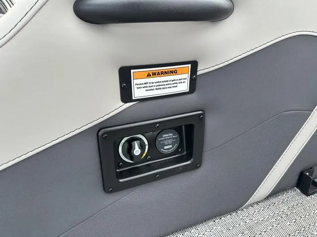 Slide: The Image of 2025 Barletta Boats C20UC interior panel with warning label and digital gauge. - 34