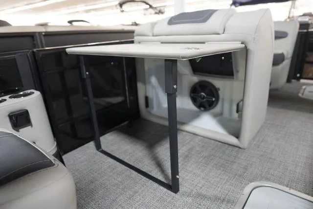 Slide: The Image of 2025 Barletta Corsa 23UC boat interior with foldable table and speaker system. - 13