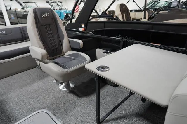 Slide: The Image of 2025 Barletta Corsa 23UC boat interior with plush seating and table setup. - 14