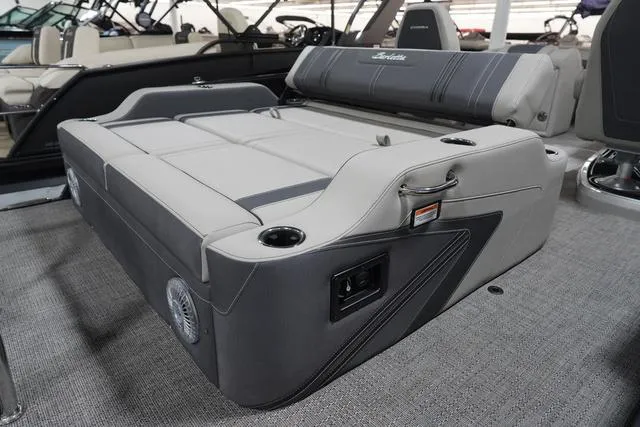 Slide: The Image of 2025 Barletta Corsa 23UC boat interior with luxurious seating and cup holders. - 23