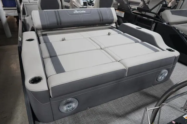 Slide: The Image of 2025 Barletta Corsa 23UC boat interior with luxurious seating and integrated speakers. - 24