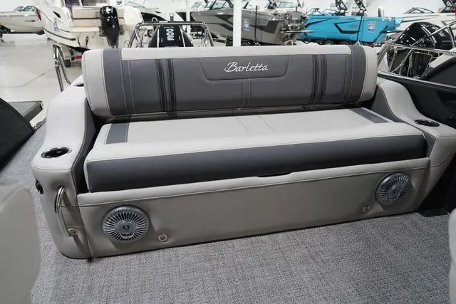 Slide: The Image of 2025 Barletta Corsa 23UC boat interior with gray seating and integrated speakers. - 28