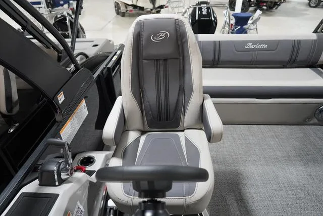 Slide: The Image of Captain's seat of 2025 Barletta Corsa 23UC boat, featuring sleek design and comfortable upholstery. - 29