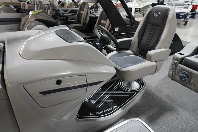 Slide: The Image of 2025 Barletta Corsa 23UC boat interior with sleek captain's chair and modern dashboard. - 37
