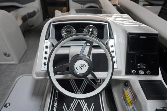 Slide: The Image of 2025 Barletta Corsa 23UC boat dashboard with steering wheel and modern controls. - 43