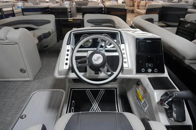 Slide: The Image of 2025 Barletta Corsa 23UC boat interior with modern steering console and seating. - 44