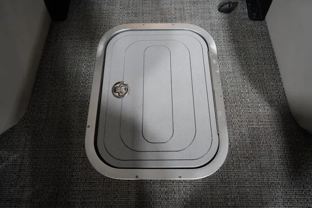 Slide: The Image of Hatch on 2025 Barletta Corsa 23UC boat, featuring textured flooring and secure latch. - 8