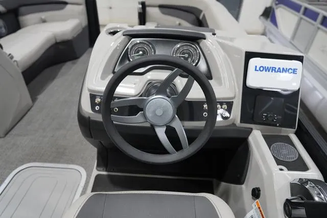Slide: The Image of 2025 Barletta Boats C22QC dashboard with steering wheel and Lowrance navigation system. - 11