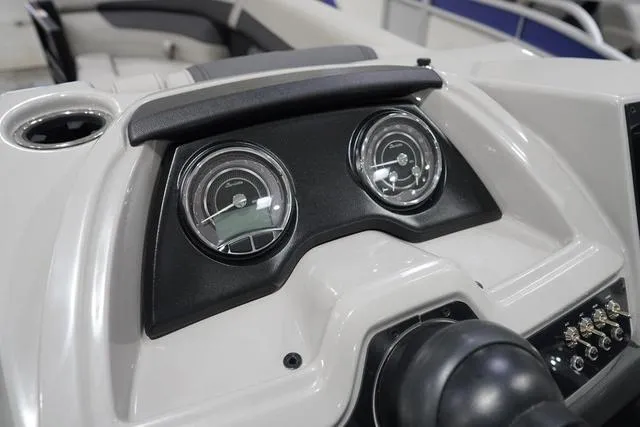 Slide: The Image of Dashboard of 2025 Barletta Boats C22QC, featuring dual gauges and control panel. - 13