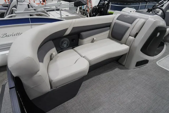 Slide: The Image of 2025 Barletta Boats C22QC interior seating with gray upholstery and integrated speaker system. - 19