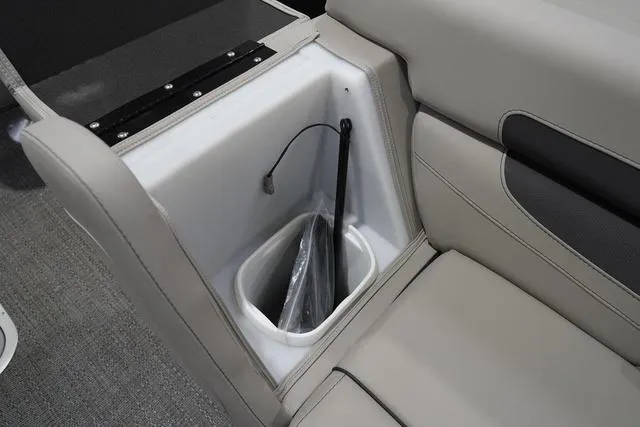 Slide: The Image of Interior storage compartment of 2025 Barletta Boats C22QC with beige seating. - 22