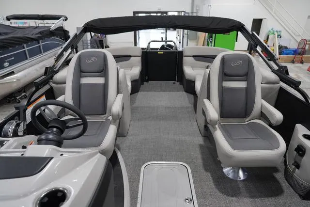 Slide: The Image of 2025 Barletta Boats C22QC interior with plush seating and modern steering console. - 24