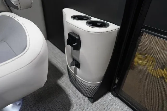 Slide: The Image of Cup holders and controls in 2025 Barletta Boats C22QC interior. - 28